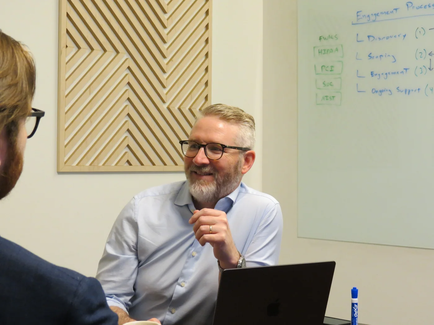 A Sidechain engineer in a scoping conversation in front of an engagement process whiteboard.